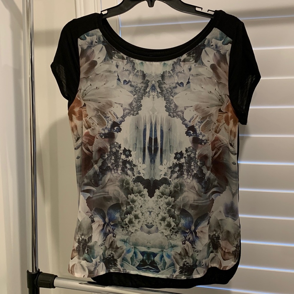 Bebe sheer tee with design on front and back is solid black. Size medium